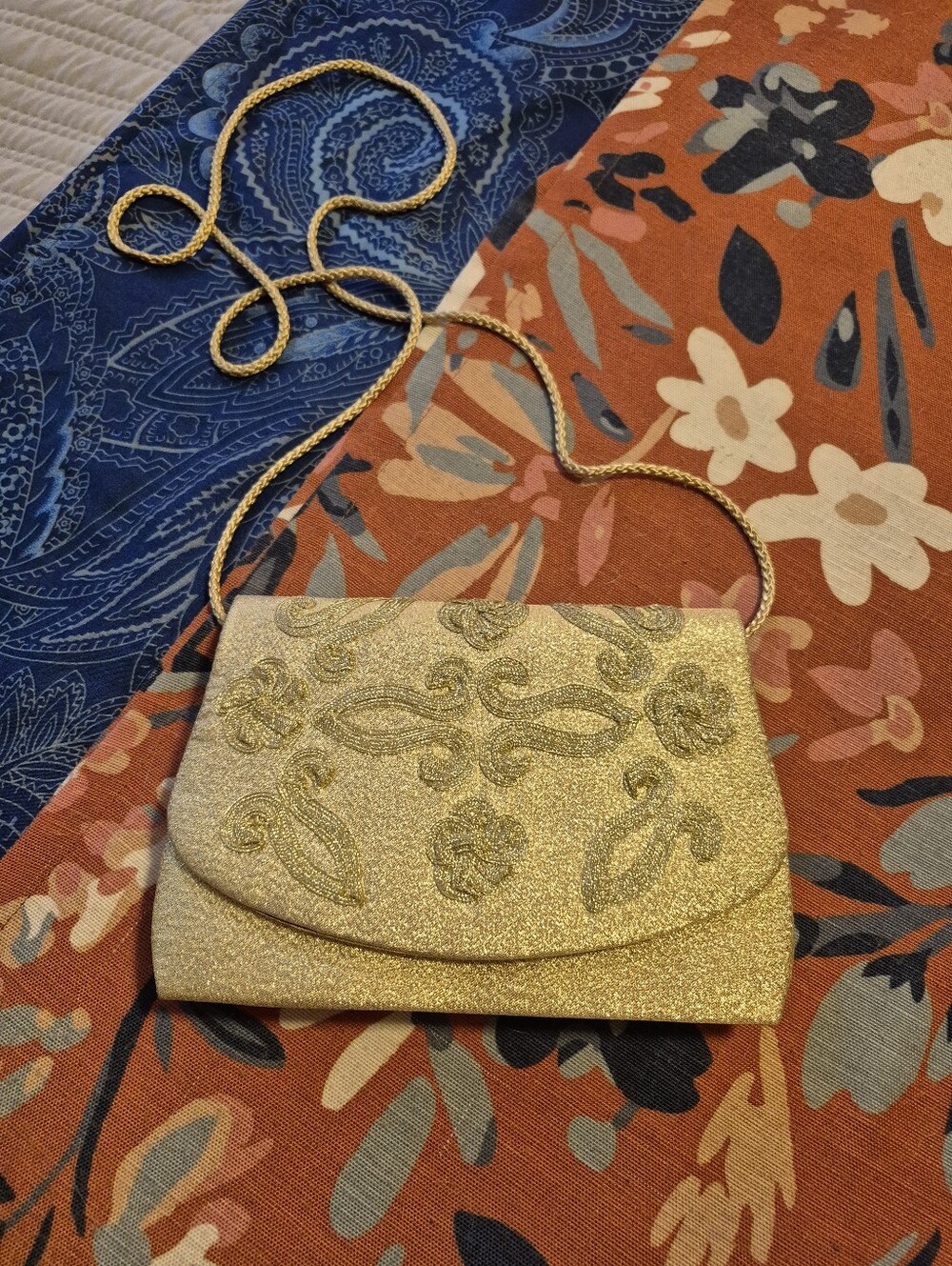 Elegant vintage gold evening clutch features shimmering fabric accents.